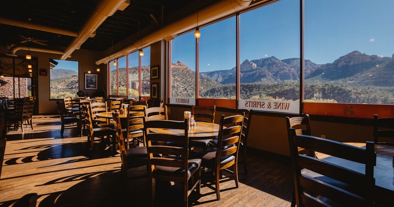 Interior, tables, chairs, aview of the mountains and the prairie