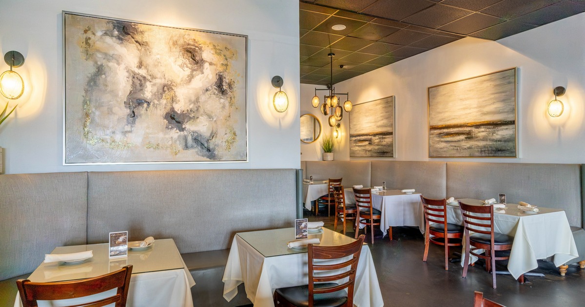 Interior, elegant dining space with large paintings on the walls