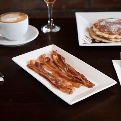 Bacon strips, pancake plate, cup of coffee and wine.