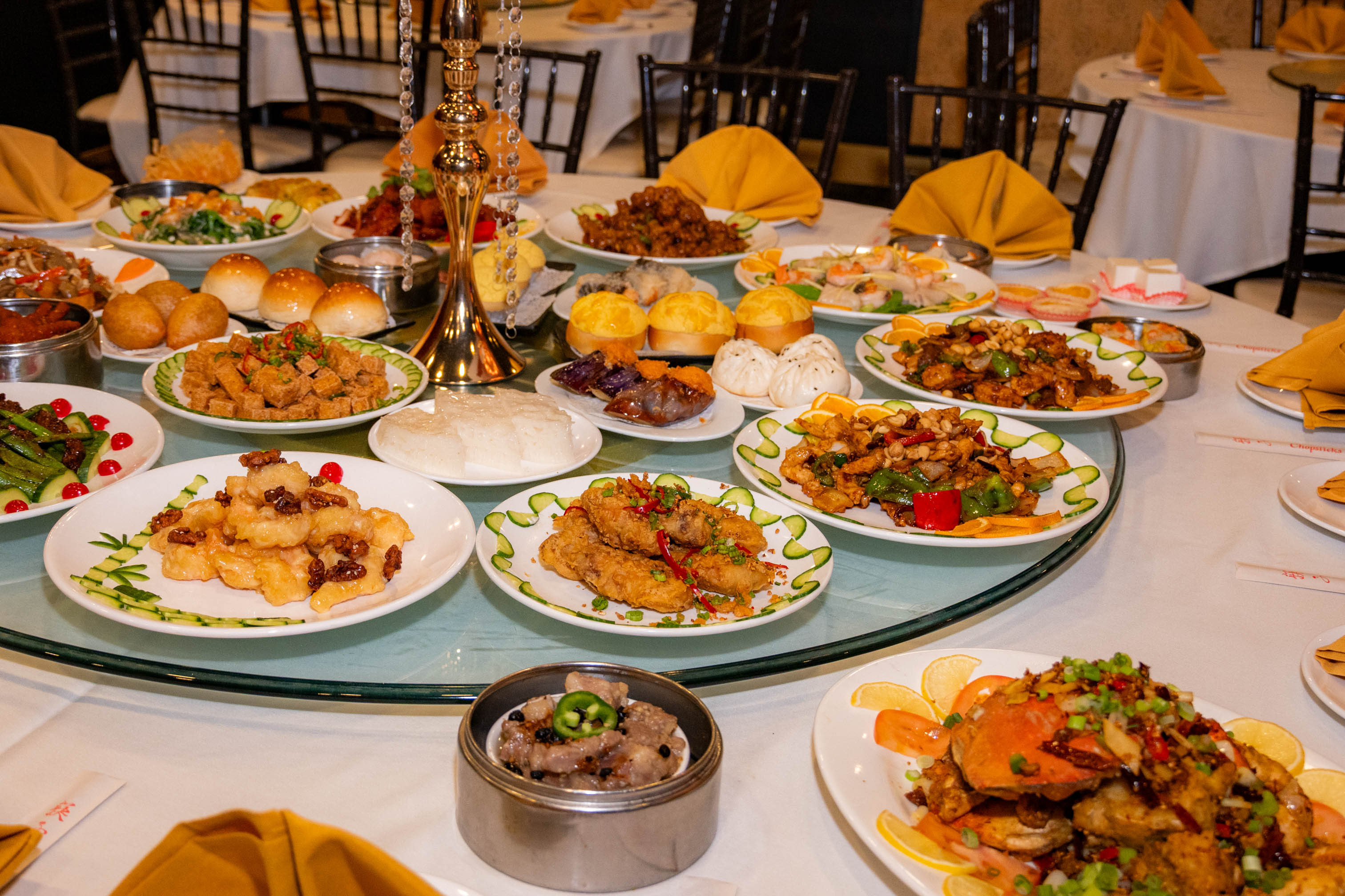 Variety of dishes served on a glass lazy Susan at a restaurant table