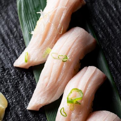 Close up view of yellow tail nigiri sushi.