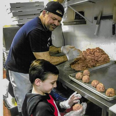 A chef and a child working in the kitchen