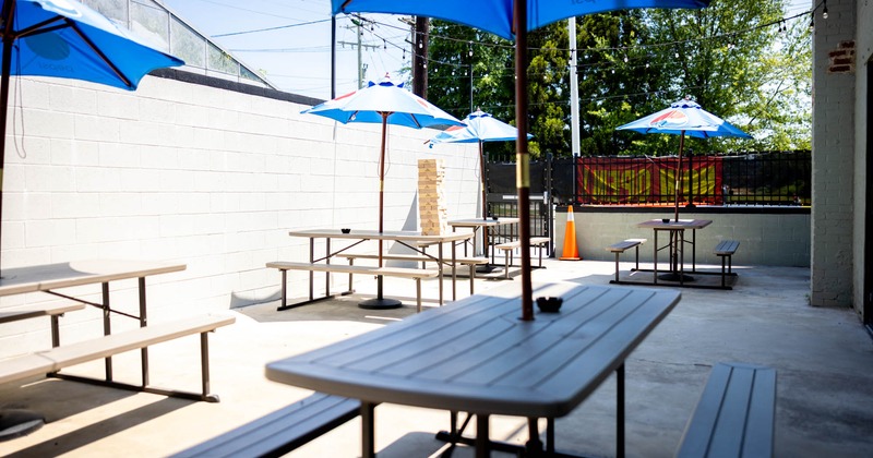 Exterior, partially covered seating area, tables with benches under parasols