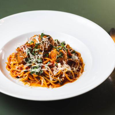 Spaghetti & Meatballs, in tomato sauce, sprinkled with cheese.