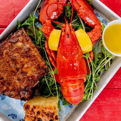 Surf and Turf, lobster, a half rack of smoked ribs and cornbread