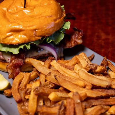 The Conway burger with a side of fries and a pickle.