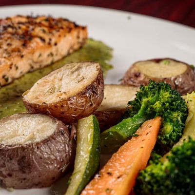 Close up of grilled vegetables on a salmon plate.