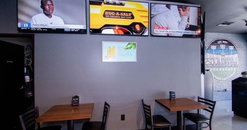 Tables for two,  TVs on the wall