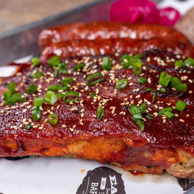 Meat plate with Korean BBQ ribs, sausage, brisket and pickled onions