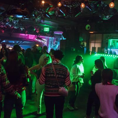 Club guests in the green lighting