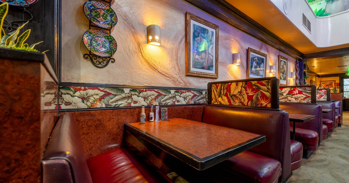 Interior, dining area, leather seating booths with tables, framed paintings as a decoration