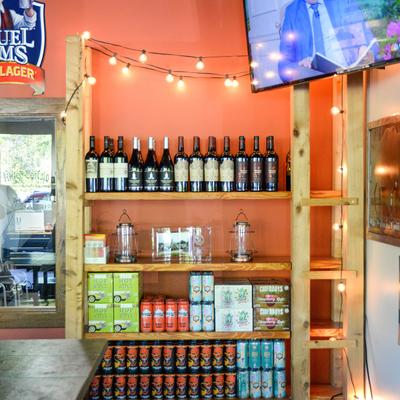 Various wine bottles and cans on the shelf