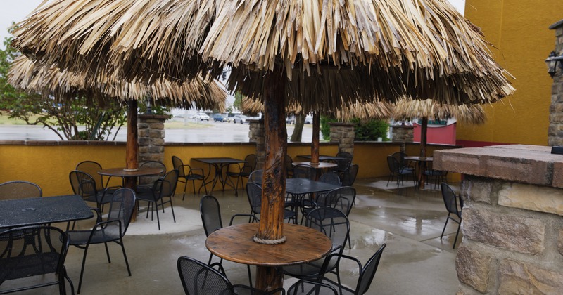 Tables and chairs above palm tree parasols