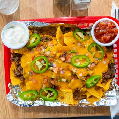 Philly nachos served with sour cream and salsa.
