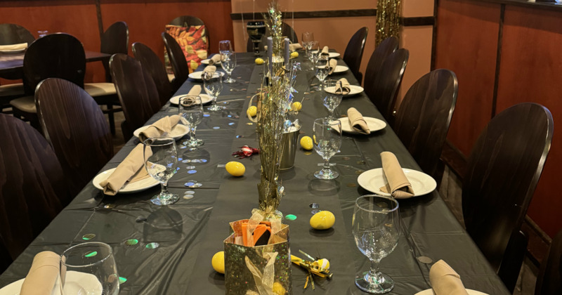 Interior, tables set for guests with picture on the wall in background