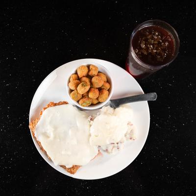 Chicken fried steak with white gravy,  served with fried okra and potato salad.