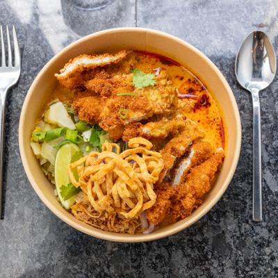 Thai curry noodle soup with fried chicken.