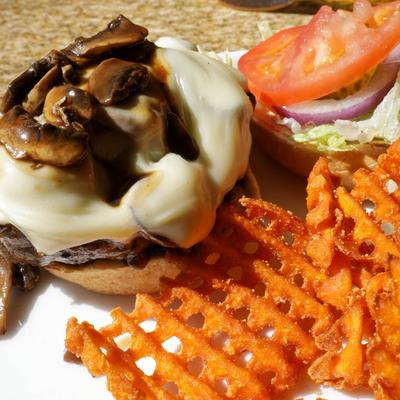 Mushroom Swiss Burger, and a side of sweet potato waffle fries.