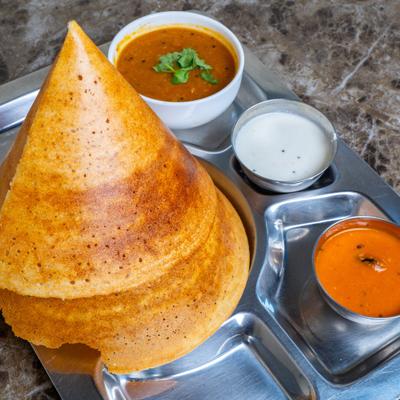 Dosa served with two chutneys and a stew.