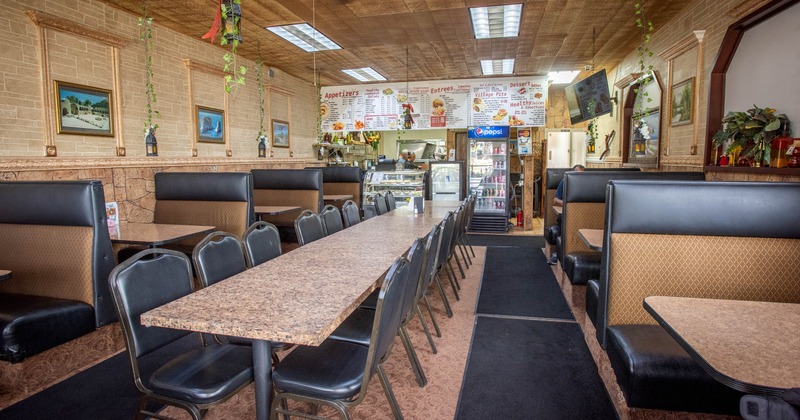 Interior, dining area with one long table and leather booths on the sides
