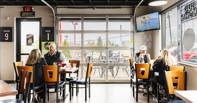 Interior, guests enjoying their food, tv on the wall