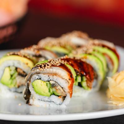 Green Dragon Rolls, with eel, avocado, cucumber, eel sauce, and sesame seeds.