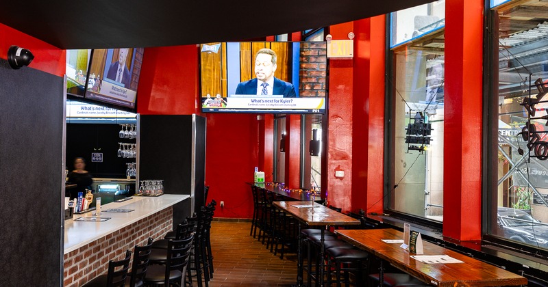 Bar area with a windiw seating space and a TV screen