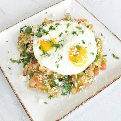 Chilaquiles topped with two sunny side up eggs.