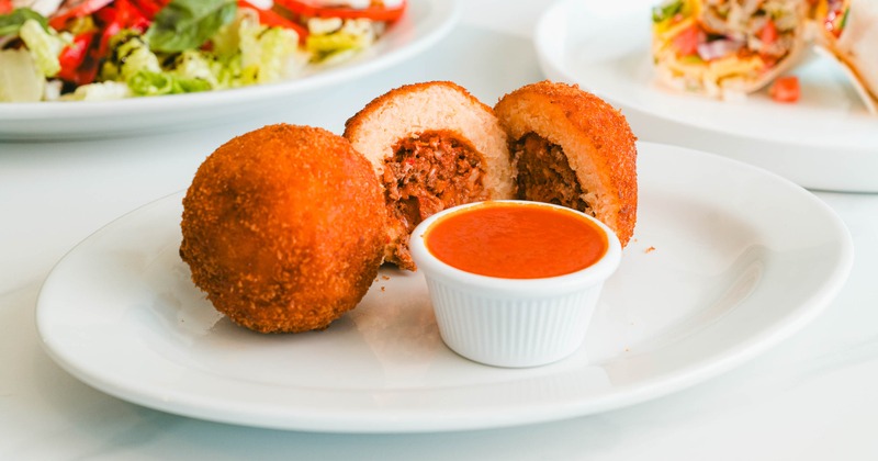 Beef Rice Balls served on a plate with a dip on the side