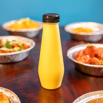 Served meals and a mango lemonade on the table.