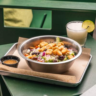 Greek Salad, with lettuce, tomato, onion, cucumber, olives, feta, and croutons.