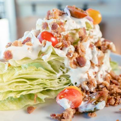 Wedge salad topped with blue cheese dressing.
