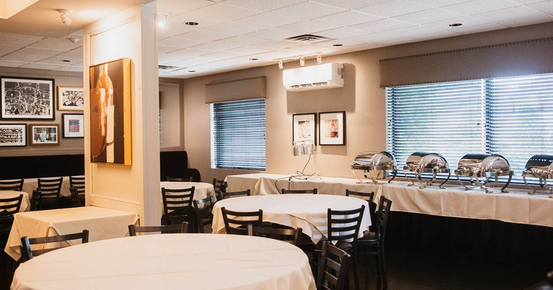 Interior, tables with white table cloths and a buffet table