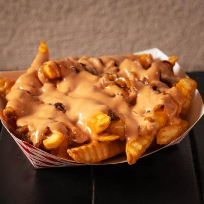 Fries with grilled onions and cheese sauce.