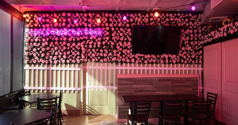 Interior, tables, chairs, wall TV, flower arrangements on the wall, lighting, doors