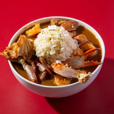 Gumbo served with rice and crab pieces.