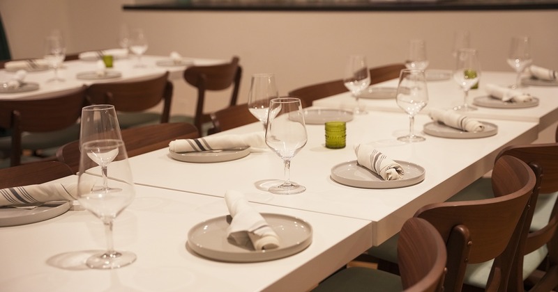 Dining table with tableware and wine glasses close up