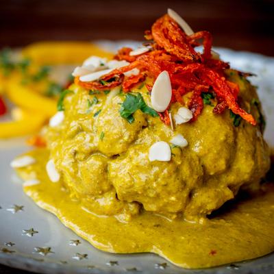 Grilled cauliflower simmered in yogurt, cashews, and fresh mint, topped with slivered almonds.