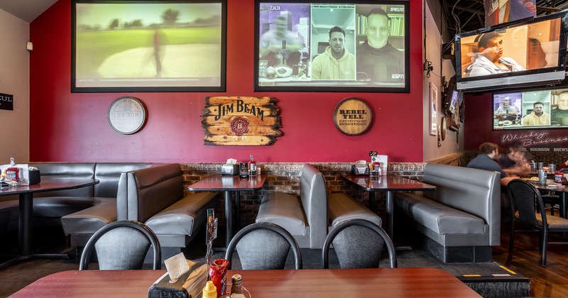 Interior space, dining booths, TV sets on the wall