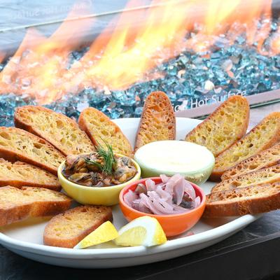 Platter of crostini served with various dips and toppings.