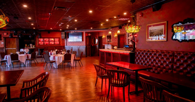 Governor's Hall interior with rich red walls, wood flooring, and classic furnishings