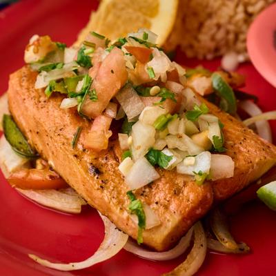 Grilled salmon on a bed of fajita veggies topped with pico de gallo.