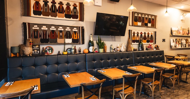 Restaurant interior, tables with cutlery lined up, wall decorations