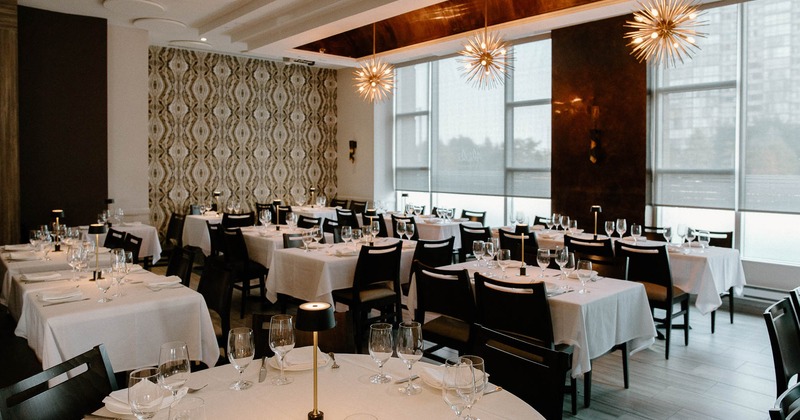 Interior, tables set for guests in dining area