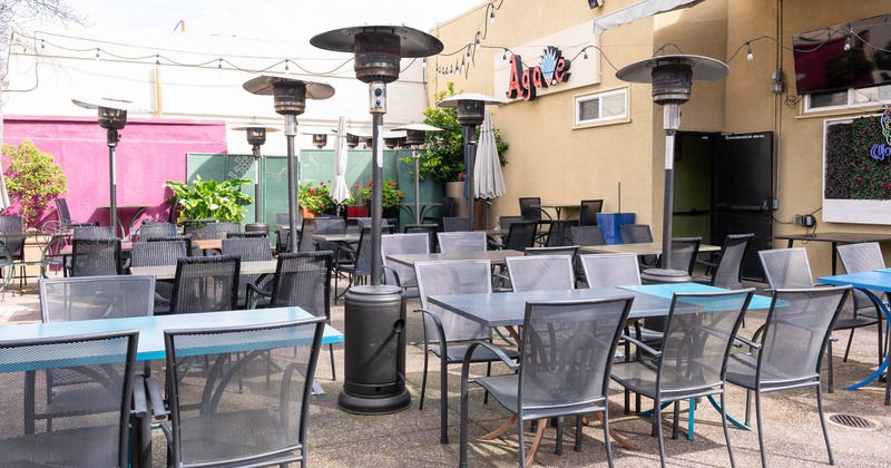 Exterior, uncovered seating area, tables with chairs for four and six, space heater