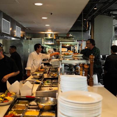 Staff preparing food in a busy kitchen.