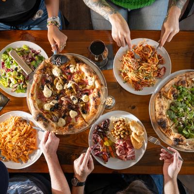Assorted dishes, hands, top view