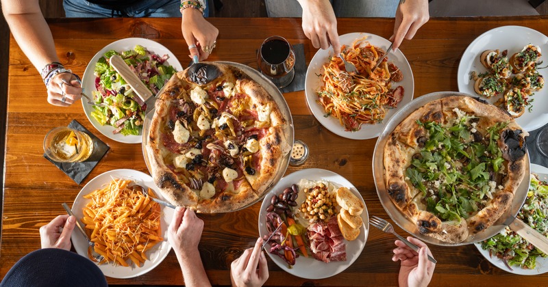 Assorted dishes, hands, top view