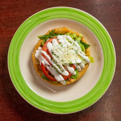 Fried masa dough with various toppings.