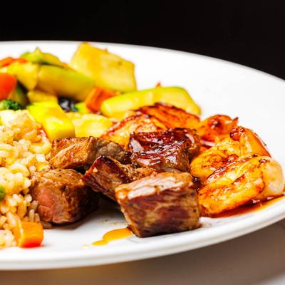 Hibachi Steak and Shrimp with hibachi fried rice and vegetables, close up.